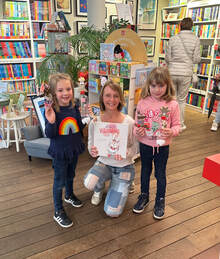 Picture Heather at bookstore with two children holding copy of Paisley's Big Birthday book